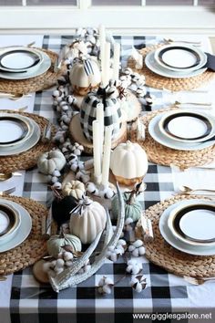 the table is set with white and black dishes