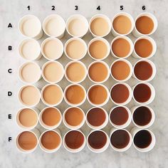 several rows of cups with different types of sauces in them