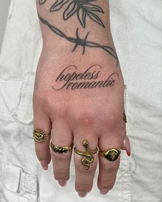 a person with two rings on their fingers and the word happiness written in cursive writing