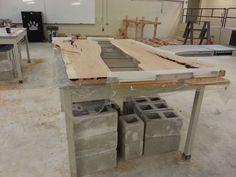 some concrete blocks sitting on top of a workbench in a building that is being built