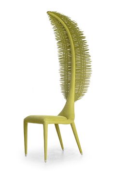 a yellow chair that is shaped like a spirally curved piece of metal, on a white background