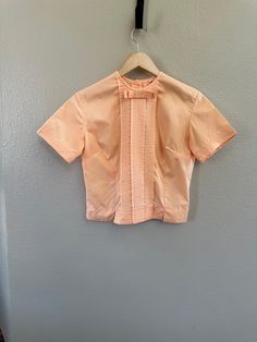 Vintage Womens tuxedo front short peach shirt unknown brand, size or age. no holes or stains, has all the buttons Fitted Elegant Orange Blouse, Elegant Fitted Orange Blouse, Retro Formal Spring Tops, Retro Spring Formal Tops, Spring Retro Formal Tops, Retro Formal Blouse For Spring, Retro Spring Blouse For Formal Occasions, Vintage Pink Blouse For Formal Occasions, Formal Short Sleeve Tops For Spring