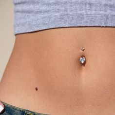 a woman's stomach with a tiny diamond on it