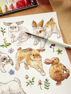 an artist's watercolor drawing of dogs and puppies with paintbrushes