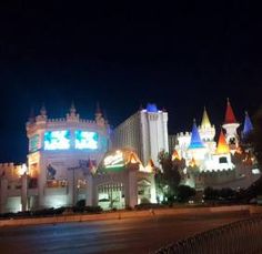 the las vegas hotel and casino is lit up at night with colorful lights on it