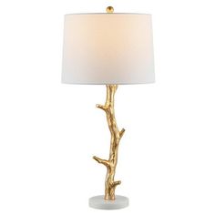 a gold tree branch lamp with a white shade