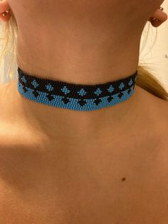 Hand beaded with premium Czech glass seed beads in black and cyan blue with premium Miyuki nylon threads. Pattern is a star like diamond. Lobster claw closure with a stainless steel chain collar. Beaded length is 12 inches with an extension of 2 1/2 inches. Hypoallergenic and nickel free. Bead Loom Choker, Turquoise Beaded Necklaces With Black Beads For Festival, Blue Tiny Beads Choker For Festival, Blue Beaded Chain Choker For Festival, Blue Beaded Choker For Festival, Blue Necklaces With Black Beads For Festival, Blue Necklace With Black Beads For Festival, Blue Beaded Chain Choker, Turquoise Jewelry With Black Beads For Festival