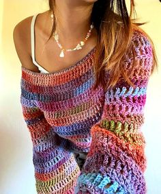 a woman wearing a multicolored knitted sweater