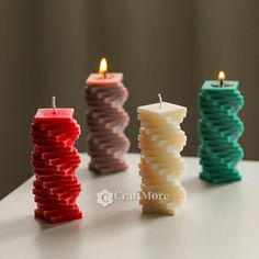 three candles sitting next to each other on a table