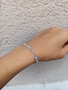 Color: silver Material: 925 solid silver Bracelet size: 16 cm 6 millimeter Evil eye size: 6 millimeter Name disk size : 2.8 cm 6mm note: If you want different size of bracelet, please contact me. 925 sterling solid silver bracelet has a very solid structure. I can engrave what you want on it. Evil eye detail on the side looks very elegant and beautiful. You will love this silver bracelet. https://www.etsy.com/shop/Hirajewelrydesign?ref=seller-platform-mcnav Personalized Blue Sterling Silver Bracelets, Silver Evil Eye Bracelets In Sterling Silver, Sterling Silver Evil Eye Bracelets, Sterling Silver Evil Eye Bracelet In Silver, Silver Name Bangle Bracelet, Silver Evil Eye Bangle Bracelet For Gift, Silver Evil Eye Bangle Bracelet Gift, Silver Evil Eye Bracelet For Gift, Blue Sterling Silver Engraved Bracelet