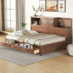 a bed sitting in a bedroom on top of a hard wood floor next to a window