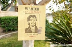 a wanted dead of alive sign hanging on a tree