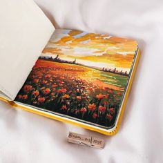 an open book sitting on top of a bed