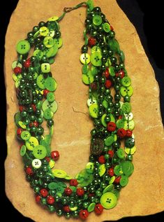 a necklace made out of buttons and glass beads