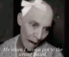 a man with a white bow on his head is looking at the camera and has words written in front of him