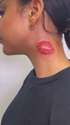 a woman with red lipstick painted on her neck