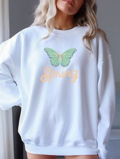 This Spring Butterfly sweatshirt is perfect for welcoming warmer weather. Great gift for Easter, Mothers Day or to kick off Spring.  Ideal for any situation, a unisex heavy blend crewneck sweatshirt is pure comfort. These garments are made from polyester and cotton. This combination helps designs come out looking fresh and beautiful. The collar is ribbed knit, so it retains its shape even after washing. There are no itchy side seams on these sweaters.  .: 50% cotton, 50% polyester .: Medium-heav Spring Graphic Print Crew Neck Sweater, White T-shirt With Ribbed Cuffs For Spring, White Letter Print Sweater For Spring, Relaxed Fit Sweater For Spring Leisure, Spring Loungewear Sweatshirt With Comfortable Fit, White Crew Neck Sweatshirt For Spring, White Crew Neck T-shirt For Spring, White Cotton Leisure Sweatshirt, White Cotton Sweatshirt For Leisure