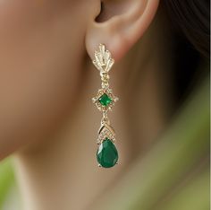 High quality champagne gold plated Gatsby style earrings with emerald and clear cubic zirconia stones.  There are 2 jewelry box options: Box A: regular jewelry cardboard box with a textured diamond pattern on the outside (comes in white, black or red) Box B: Velvet earring and necklace box (comes in green, red and grey) You can also add a mini gift bag as show in the pics: comes with green, red or grey satin ribbon and a few sheets of gift tissue paper. Ready to ship in 1-3 business days Comes with free tracked shipping to Canada and U.S. Shipping time to Canada and U.S: 2 - 8 business days Need it within 2-3 business days? Please upgrade shipping at checkout. Add more items from my shop and save on delivery cost. If you have any questions, please message me via Etsy chat! Green Art Deco Drop Earrings, Art Deco Green Jewelry For Pierced Ears, Elegant Green Chandelier Earrings For Pierced Ears, Elegant Green Gemstone Chandelier Earrings, Elegant Green Gemstone Clip-on Earrings, Elegant Green Clip-on Earrings, Gold Emerald Earrings For Evening, Green Elegant Crystal Earrings For Evening, Elegant Green Crystal Earrings For Evening