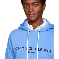 Stay comfortable and stylish with Tommy Hilfiger's Embroidered Logo Hoodie. Made with cotton, this fleece hoodie is designed for total comfort. Featuring the iconic Hilfiger signature logo and a convenient kangaroo pocket, this hoodie is the perfect addition to your wardrobe..Regular Fit: Tommy Hilfiger's Classic Pullover Hoodie made to fit comfortably..Size Medium Chest measures 44-1/2'.Model is wearing a size Medium.Drawstring hoodie for adjustable hood.Kangaroo pocket for added convenience.Cl Hooded Sweatshirt With Logo Detail For Spring, Blue Cotton Sweatshirt With Logo, Blue Hoodie With Logo Detail, Casual Blue Hoodie With Logo Detail, Casual Blue Hoodie With Logo, Blue Long Sleeve Hoodie With Logo Detail, Blue Long Sleeve Hoodie With Logo, Hooded Hoodie With Logo Detail For Spring, Blue Hooded Sweatshirt With Logo Detail