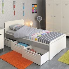 a child's bedroom with white furniture and colorful rugs