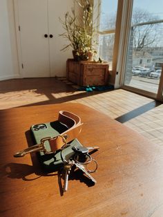 two keys laying on top of a wooden table