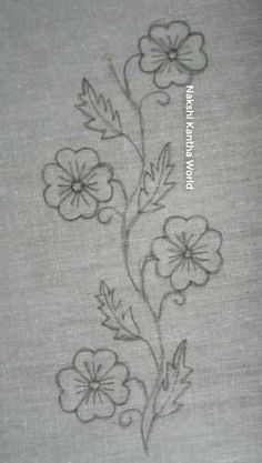 a close up of a piece of cloth with flowers and leaves drawn on the fabric