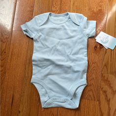 New With Tags! Excellent Condition. Light Baby Blue. Cute Blue Short Sleeve Bodysuit For Summer, Blue Casual Short Sleeve Bodysuit For Summer, Casual Blue Short Sleeve Bodysuit For Summer, Solid Color Short Sleeve Onesie For Playwear, Casual Blue Cotton Bodysuit, Solid Color Short Sleeve Bodysuit For Playtime, Solid Short Sleeve Bodysuit For Playtime, Blue Fitted Cotton Short Sleeve Bodysuit, Blue Cotton Short Sleeve Bodysuit