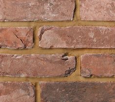 a close up of a brick wall that has been made with red bricks and mortar