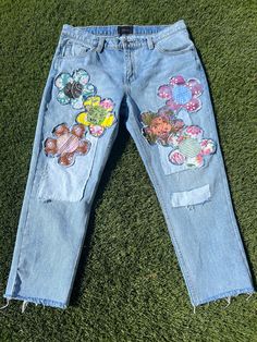 Don't want to wear what everyone else is wearing?  These super cute Patched upcycled mens Rola boyfriend cut jeans are perfect for the unique trendsetter you are!  Wear them oversized if you're smaller than a 36 just belt them and you'll be good to go!  There are assorted flower patches on the front  sourced from thrifted and vintage fabrics.  Pair them with a solid top,  your fave converse and you're good to go.  If you would like these cut shorter with a raw frayed hem just lmk your inseam and I will cut and fray for you.  Waist   37 inches Rise  11.5 inches Inseam  26 inches  hips  48 inches Back rise  16 inches  Thigh  26 inches  stretch - nope Rise is the most important measurement, as it determines where all the other measurements will fall. Please compare these measurements to your Boyfriend Cut Jeans, Hippie Jeans, Patched Denim Jeans, Reconstructed Clothing, Denim Crafts Diy, Shabby Chic Clothes, Patchwork Jeans, Denim Patches, Patched Jeans