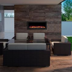 a living room with couches, chairs and a fire place in the fireplace area