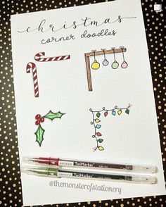 a notepad with christmas doodles on it next to a marker pen and some candy canes