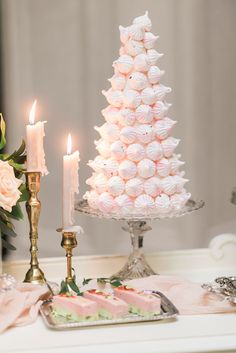 a table topped with cakes and candles next to a cake on top of a plate