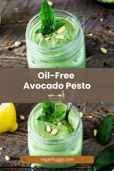 two jars filled with green pesto on top of a wooden table