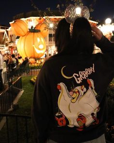 the back of a woman's sweatshirt with an image of a cartoon character on it