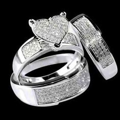 two white gold wedding rings with pave set diamonds on each one and matching bands