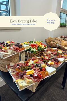 several trays filled with different types of food on top of a table in front of a window