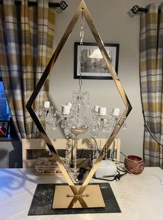 a table topped with a chandelier next to a window