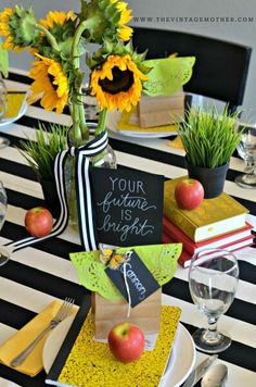 the table is set with sunflowers, apples and napkins for an autumn themed party