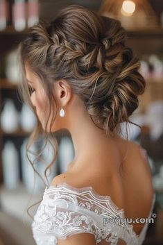 a woman with long hair in a wedding dress is looking down at her shoulder and back