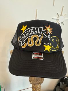 Otto brand trucker hat with Original and snake patch with other accent patches. Fun and funky fashion! Adjustable Black Hats With Patches, Black Adjustable Hat With Patches, Adjustable Black Hat With Patches, Trucker Hat With Embroidered Patch For Streetwear, Trucker Snapback Hat With Curved Brim And Patches, Trendy Baseball Cap With Patches And Curved Brim, Trendy Snapback Hat With Logo Patch For Streetwear, Streetwear Trucker Hat With Embroidered Patch And Flat Brim, Flat Brim Trucker Hat With Embroidered Patch For Streetwear