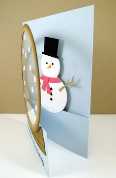 a card with a snowman inside of it