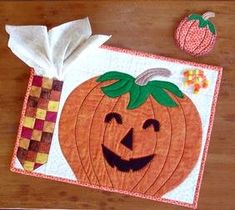 a napkin with a pumpkin on it next to a piece of paper