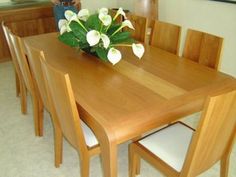 a wooden table with white flowers on it