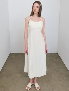 Soft and drapery, this sleeveless dress has minimalistic silhouette in long length. It is accentuated with voluminous tucked detail at chest, and has adjustable halterneck strap.  - Airy and crisp nylon fabric- Flare hem in maxi length- Fitted waist for feminine mood- Back zip fastenings- Logo embroidery detail at side Sleeveless Midi Dress With Fitted Bodice And Adjustable Straps, Sleeveless Midi Dress With Adjustable Straps And Fitted Bodice, Chic Dress With Gathered Neckline And Spaghetti Straps, Chic Spaghetti Strap Dress With Gathered Neckline, Spaghetti Strap Maxi Dress With Ruched Bodice For Daywear, Elegant Halter Neck Midi Dress For Daywear, Sleeveless Solid Midi Dress With Ruched Bodice, Solid Sleeveless Midi Dress With Ruched Bodice, Daywear Dress With Ruched Bodice And Straight Neckline