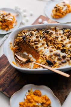 a casserole dish filled with carrots and nuts