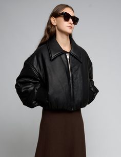 Black faux-leather crop bomber style jacket with oversized lapel. Brand Pixie Market50% polyester, 50% viscoseFully lined Oversized crop fitDropped shouldersBalloon sleeves Wide ribbed sleeve cuff Gathered elastic waist Model is wearing one size and model's height is 5.9"Imported Oversized Collared Leather Jacket For Winter, Black Cropped Jacket With Ribbed Cuffs For Fall, Cropped Leather Jacket For Fall Streetwear, Cropped Leather Jacket For Winter Streetwear, Oversized Outerwear With Ribbed Collar For Spring, Cropped Winter Outerwear With Ribbed Cuffs, Fall Leather Jacket With Ribbed Collar, Oversized Collared Cropped Jacket For Fall, Oversized Cropped Winter Outerwear