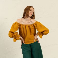 📏 FIT Jessica top is true to size, and has a regular fit. We suggest taking your usual size in this style to achieve the look as shown in pictures. Please note, the garment naturally softens and relaxes as you wear it throughout the day. It'll become more comfortable as you move around in it. 👉Model wears Spicy Yellow color. Model is 179cm/5'87" tall and wears a size S. Bust 83cm / 32.6"; Waist 67cm / 26.3"; Hips: 91cm / 35.8". ❤️ DESCRIPTION Jessica features an enticing off-shoulder design that showcases your shoulders, complemented by an elastic neckline and wrists for a snug fit. The long sleeves lend an air of sophistication, flowing gracefully. Crafted from luxurious linen, it feels soft against your skin and ensures comfort during intimate moments. Perfect for a candlelit dinner or Blouse With Ruffles, Linen Crop Top, Candlelit Dinner, Yellow Blouse, Summer Blouses, Boho Top, Top Vintage, Linen Blouse, Luxury Linen