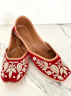 Red Punjabi Jutti with Gold Embroidery and Pearl Accents on Velvet | Punjabi Jutti for Women, Indian Jewelry, Sheeshphool, Red Flat Sandals Red is the colour of passion and love! Indian brides traditionally opt to wear red on their wedding day. Catch your special someone's eye with this stunning pair of slip on shoes in the traditional Punjabi jutti style!  What makes this red jutti different is the detailed embroidery on the velvet fabric. Vines run down either side of the front of the shoe to connect to Amb (mango) motifs. Pearls accent the embroidery with their placement throughout the shoes.   These juttis are made on genuine leather. Each jutti features a double-cushion sole, at the heels and toes, so your feet will not know pain! If your size is a 1/2 size (example 8.5) I would recom Red Traditional Wear With Pallu For Festival, Traditional Red Wear With Handwork, Red Traditional Wear With Gota Work For Celebration, Red Gota Work Traditional Wear For Puja, Red Traditional Wear With Gota Work For Puja, Red Traditional Wear With Dori Work, Red Bohemian Traditional Wear For Celebrations, Red Embroidered Traditional Wear For Transitional Season, Red Traditional Wear With Gota Work