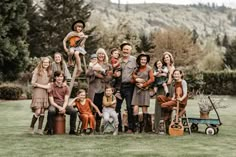 a group of people standing around each other in the grass