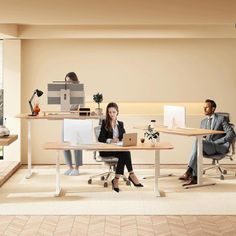 two people sitting at desks in an office setting